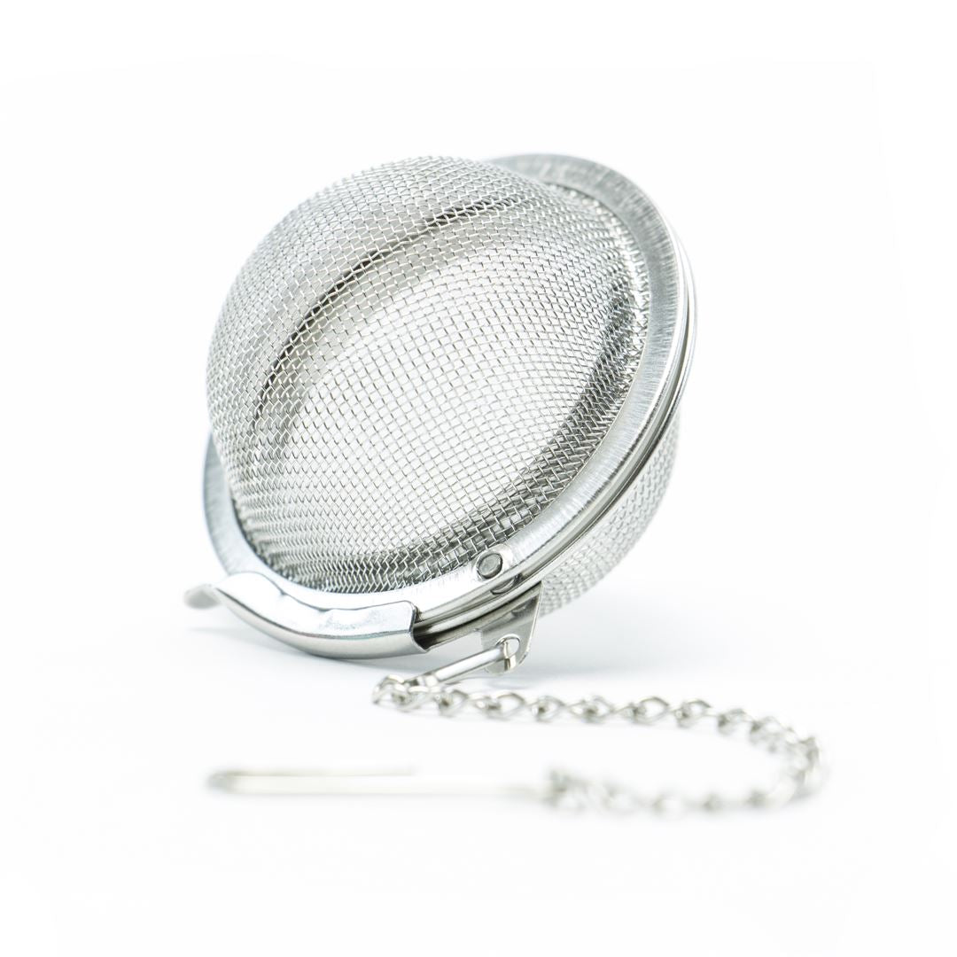 The Mesh Ball Infuser, featuring a secure latch and chain, is ideal for steeping your favorite loose leaf teas and is shown against a white background.